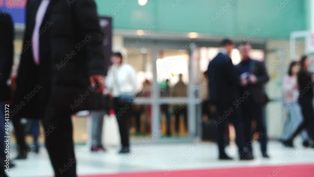 Silhouettes of unrecognizable people, in a mall lobby. Silhouettes of unrecognizable people, in a mall lobby.