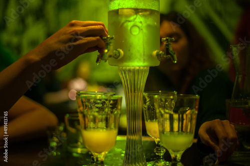 green absinthe drip fountain for a big company with four taps in a bar photo