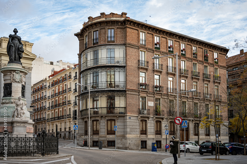 Monument to Mari Cristina de Borbon in Madrid street, classic buildings