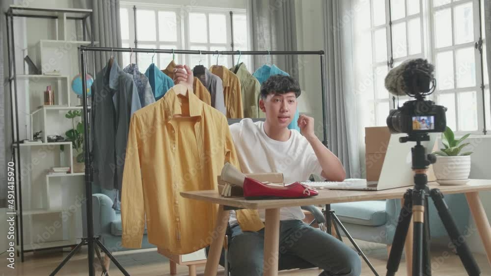 Asian Man Online Seller Recommending A Shirt And Recording Video By Camera While Using Computer For Selling Clothes At Home
Asian Man Online Seller Recommending A Shirt And Recording Video By Camera While Using Computer For Selling Clothes At Home