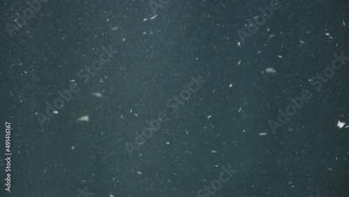 Video of dust underwater with glares on dark background