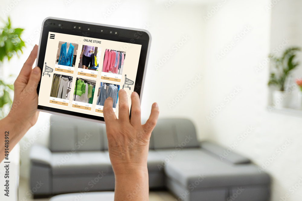 Woman looking for new clothes in online store on digital tablet