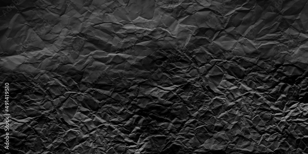 Black crumpled paper. Texture, dark background. Black crumpled paper. Texture, dark background.