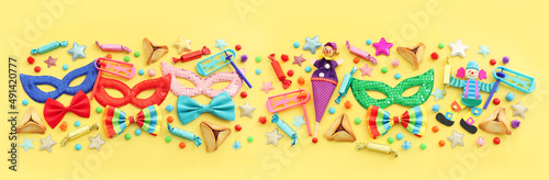 Purim celebration concept (jewish carnival holiday) over yellow background. Top view, flat lay