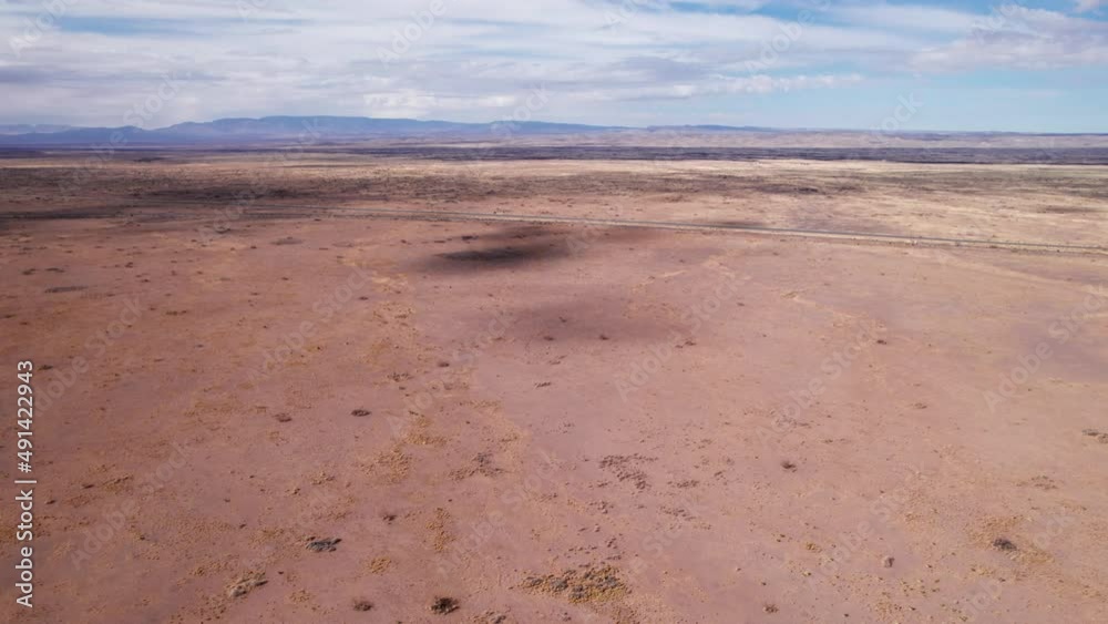 Drone shot flying forward towards a remote highway in New Mexico desert Drone shot flying forward towards a remote highway in New Mexico desert