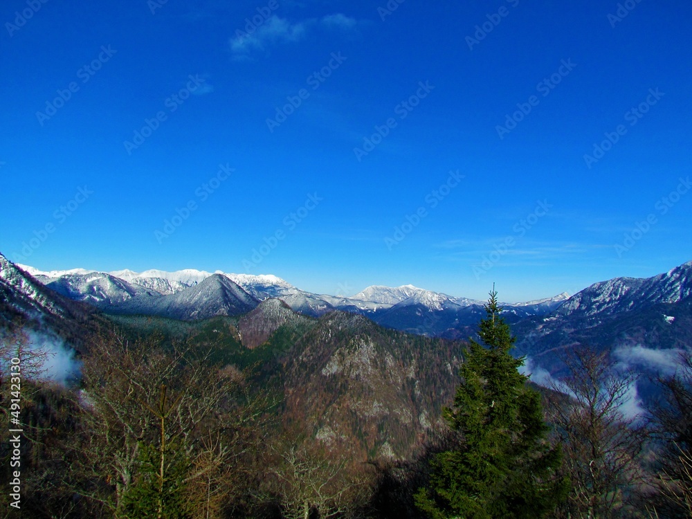 View of mountains in Karavanke mountains in Gorenjska region of Slovenia above Jezersko, Slovenia in winter with the peaks covered in snow