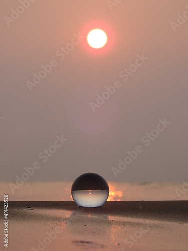 glass ball on the beach at morning