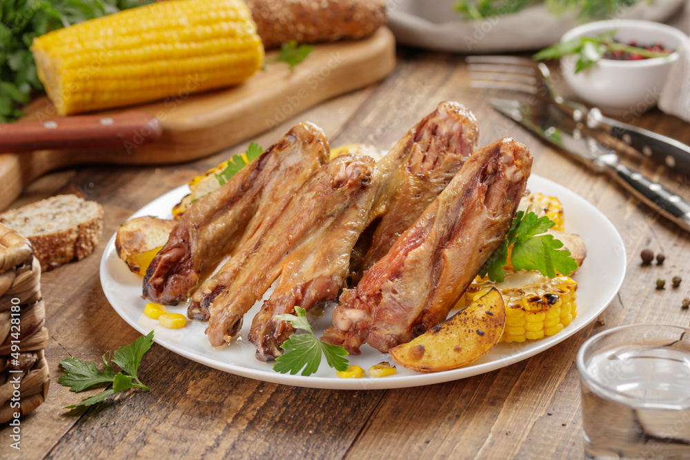 Duck/ chicken baked wings with vegetables and corn Duck/ chicken baked wings with vegetables and corn