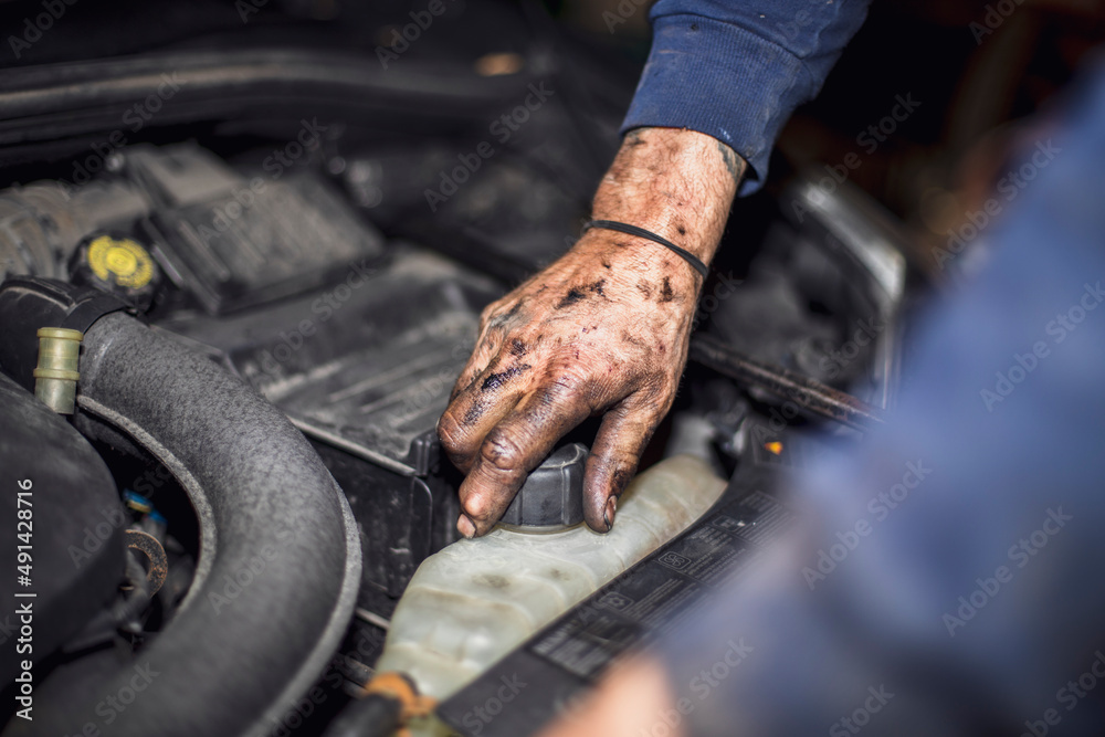 dirty hand opening coolant plug of car engine dirty hand opening coolant plug of car engine