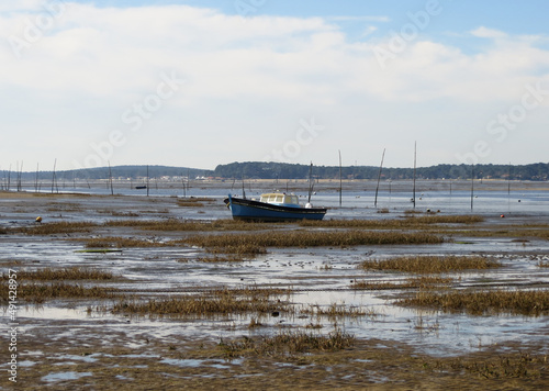 Pinasse bleue et blanche échouée dans le bassin d'Arcachon à marée basse photo