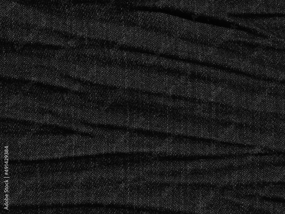 Fototapeta premium crumpled black jean texture background