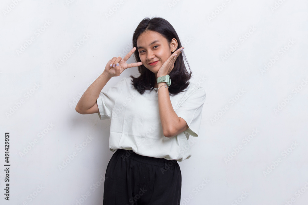 beautiful young asian girl showing peace or victory hand gesture on white background
beautiful young asian girl showing peace or victory hand gesture on white background