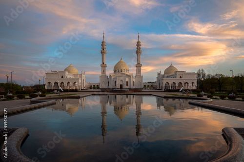 White Mosque of the ancient city of Bolgar with a reflection in the water against the background of the sunset sky. Bolgar, Republic of Tatarstan, Russia