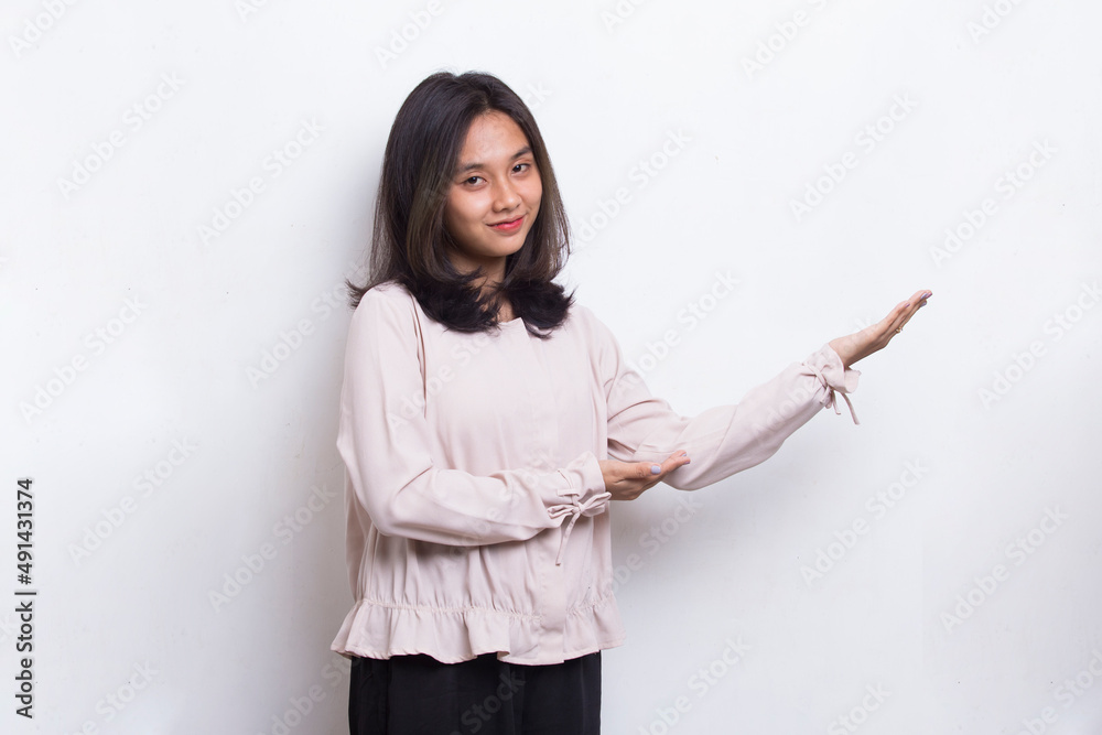 Happy young asian woman pointing with fingers to different directions isolated on white background
Happy young asian woman pointing with fingers to different directions isolated on white background