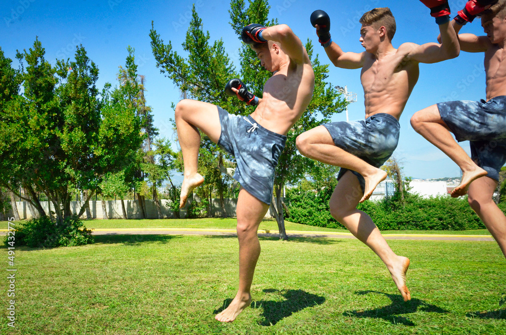Muscle Athletic Man Jumping and doing martial arts moves and training out in nature.
