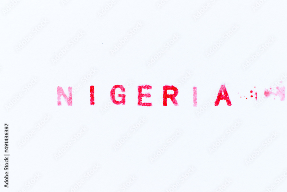 Fototapeta premium Red color ink rubber stamp in word nigeria on white paper background