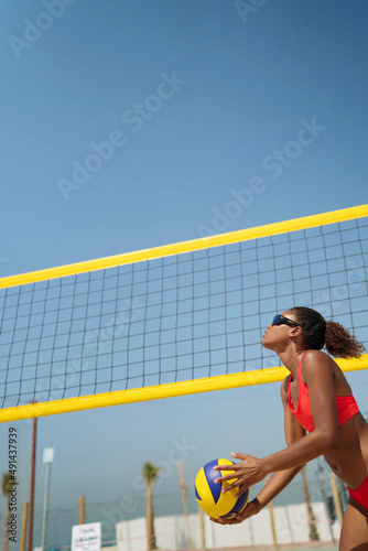Woman with afro hair playing beach volleyball