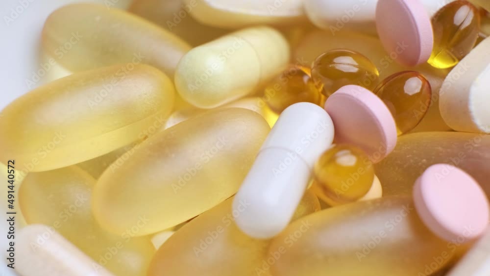 Different tablets, capsules, pills and vitamins, close-up. Healthy lifestyle and supplement intake.