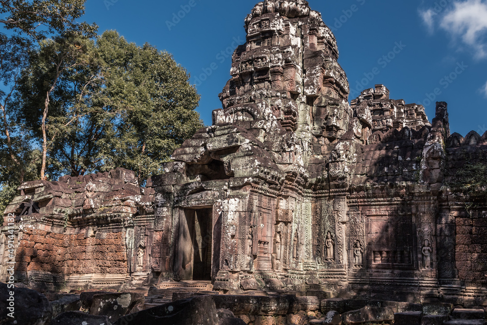 Ruins of ancient Cambodian temple among trees in Angkor complex, Siem Reap, Cambodia