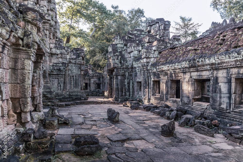 Сourtyard of ancient Cambodian temple among trees in Angkor complex, Siem Reap, Cambodia