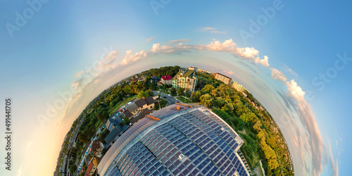 Tableau sur toile Little planet with big sustainable electric power plant with many rows of solar photovoltaic panels for producing clean ecological electrical energy