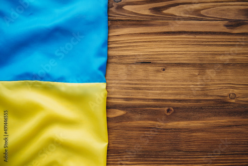 Ukrainian flag on a wooden background.
