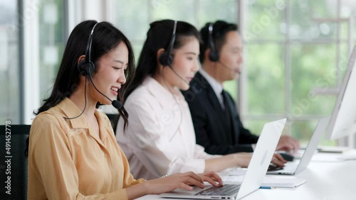 Asian call center team wearing headset and laptop keypad consulting customer in workplace. Group Service Operator Investment advise Business Finance. Active Service mind to customer. White collar 