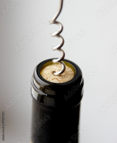 removing a wine cork from a bottle with a corkscrew 