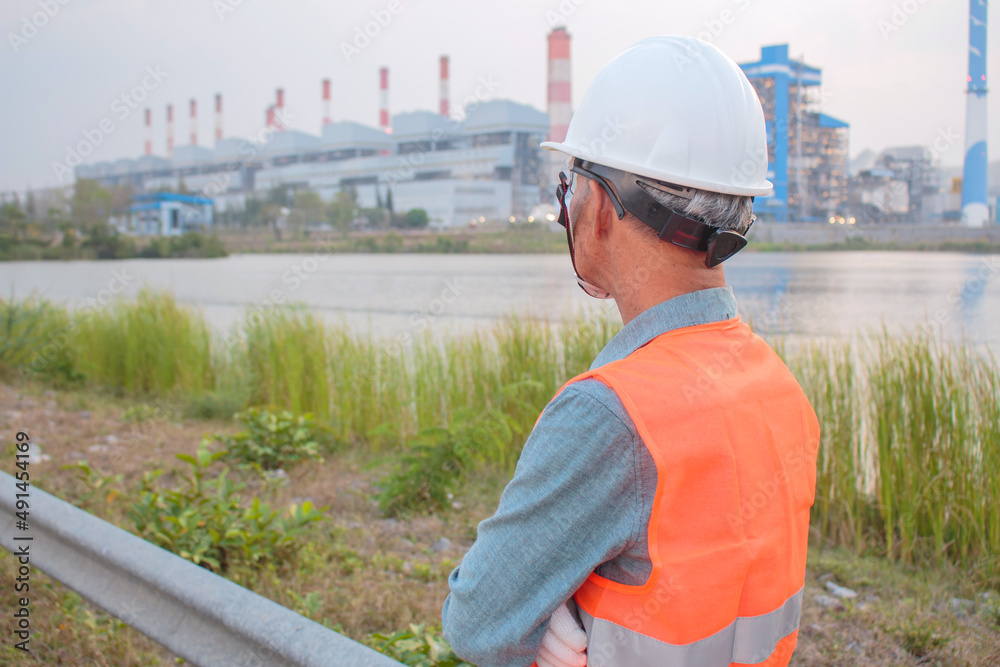 Behind a senior electrical engineer during a visit to a lignite coal-fired power plant Behind a senior electrical engineer during a visit to a lignite coal-fired power plant