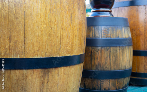 Selective focus of wooden barrel with beautiful sunlight shows concept of alcoholic beverage business including wine, rum and whiskey for using as background of vintage and grunge storage.