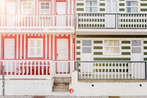 Colorful striped wooden beach houses at the promenade of Costa Nova, Aveiro, Portugal. Sunny weather
