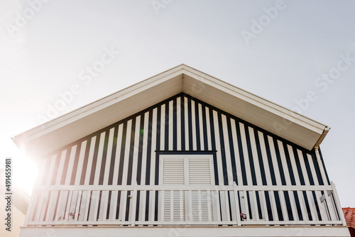 Colorful striped wooden beach houses at the promenade of Costa Nova, Aveiro, Portugal