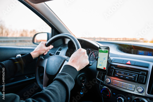 Gps device map system. Global positioning system on smartphone screen in auto car on travel road. GPS vehicle navigator driver device. © Maksym