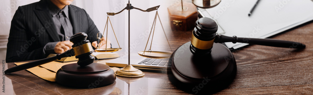 Business and lawyers discussing contract papers with brass scale on desk in office. Law, legal services, advice, justice and law concept picture with film grain effect Business and lawyers discussing contract papers with brass scale on desk in office. Law, legal services, advice, justice and law concept picture with film grain effect