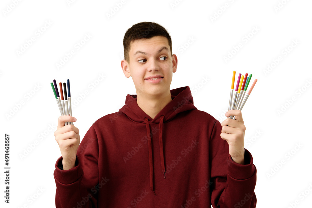 Cheerful teenage boy facing choice between boring gray life or tempting bright. Smiling student dressed maroon hoodie, isolated on white, considering what to choose. Concept of decision-making.