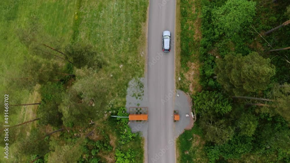 Car driving on road towards Hills Golf Club at Molndal near Gothenburg, Sweden. Aerial top-down forward Car driving on road towards Hills Golf Club at Molndal near Gothenburg, Sweden. Aerial top-down forward