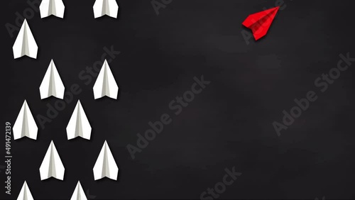 Think differently concept. Red paper plane changes direction. Blackboard background. 