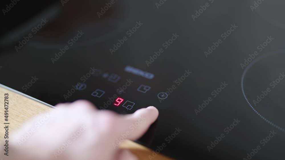 Finger turn on the electrical induction stove cooker with touch surface