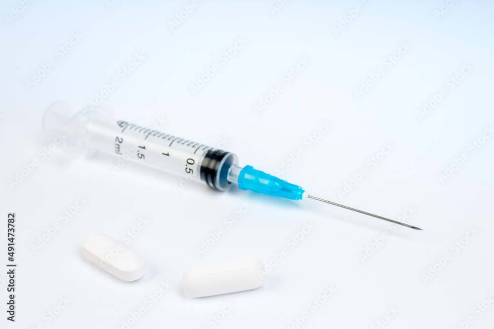 Medicine concept. Pills, syringe on white background. Copy space for text. Medicine concept. Pills, syringe on white background. Copy space for text.
