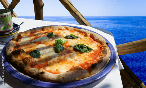 Italian pizza Margarita served on a sea view terrace photo