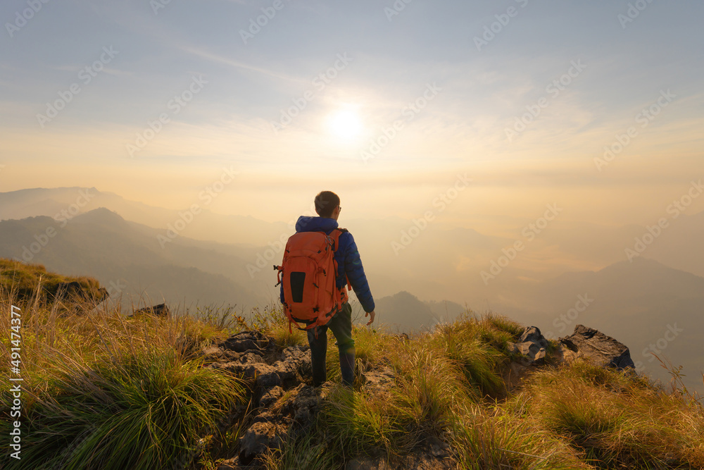Portrait of Asian man, a tourist or backpacker, travel on green mountain hills with fog on holiday vacation. Nature landscape background, Thailand. People lifestyle. Portrait of Asian man, a tourist or backpacker, travel on green mountain hills with fog on holiday vacation. Nature landscape background, Thailand. People lifestyle.