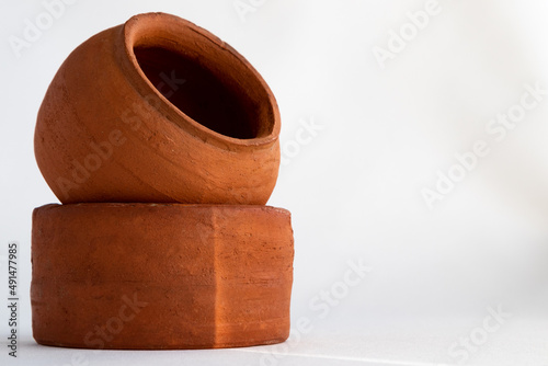 Pottery made of clay on a white background and copy space. Close-up of clay pots.