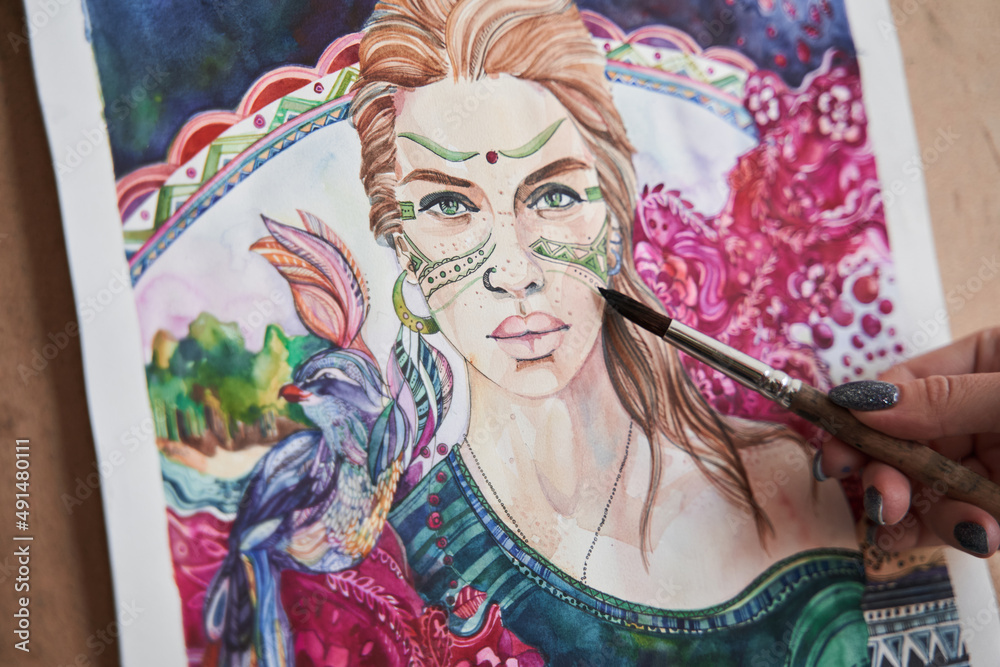 Fototapeta premium Woman drawing great art work with the brush and watercolor paints