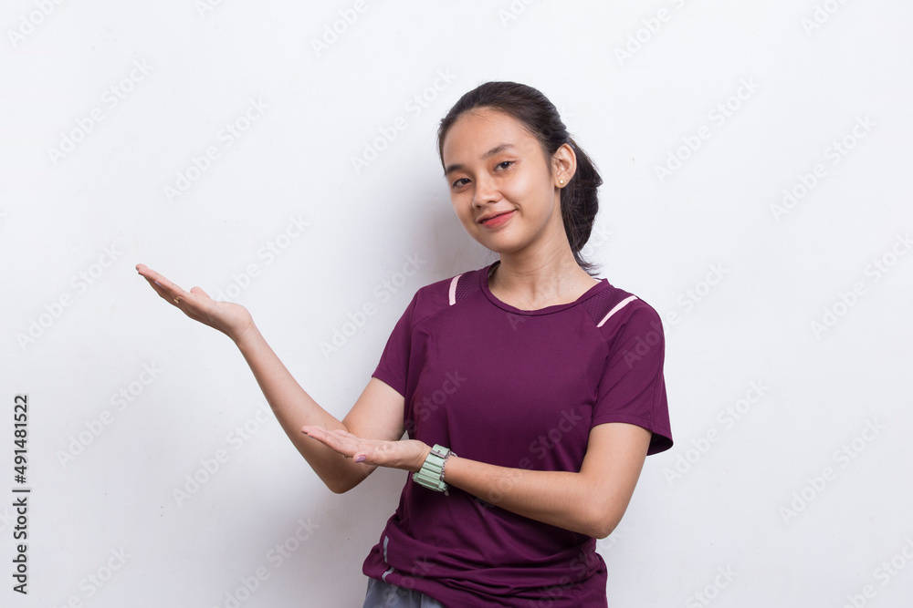 Young asian sporty woman pointing finger on empty space on white background
Young asian sporty woman pointing finger on empty space on white background