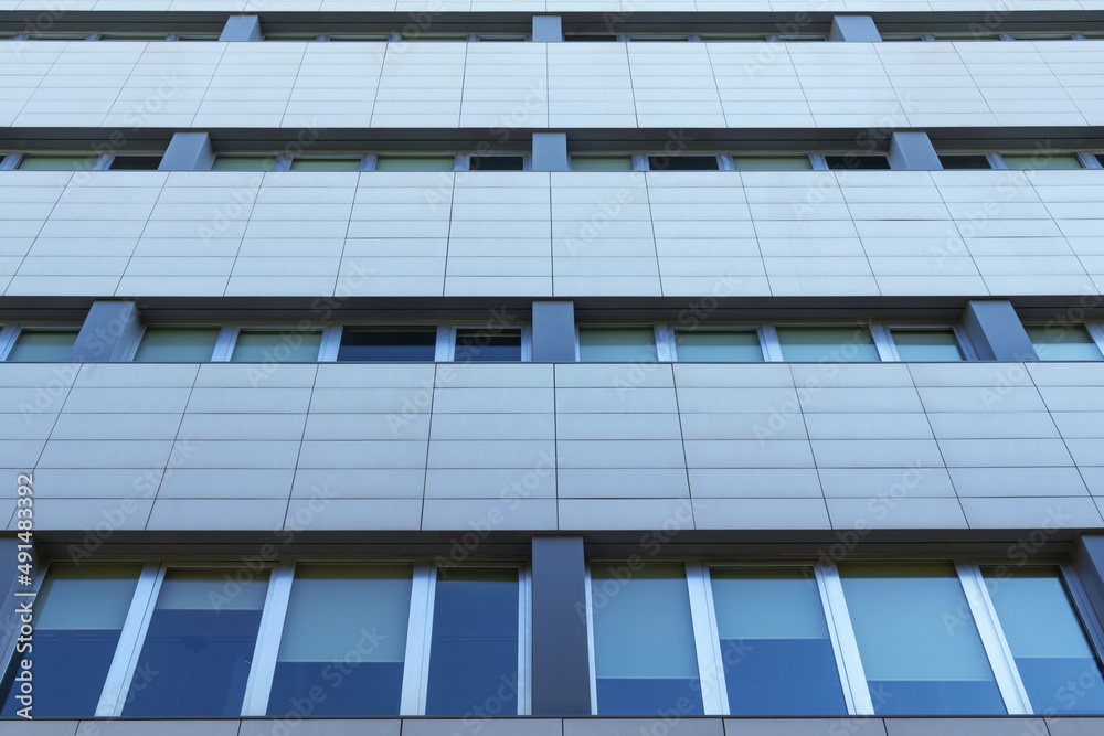 Urban modern building. Close up of an office building facade. Urban modern building. Close up of an office building facade.
