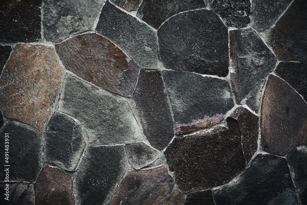 Stone wall texture background - grey stone siding with different sized stones Stone wall texture background - grey stone siding with different sized stones