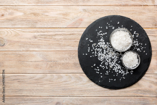 Canvas Print A wooden bowl of salt crystals on a wooden background
