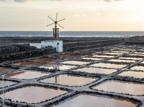 Ponds of color at sunrise, salines of Tenefe, coast of Gran canaria, Canary islands photo