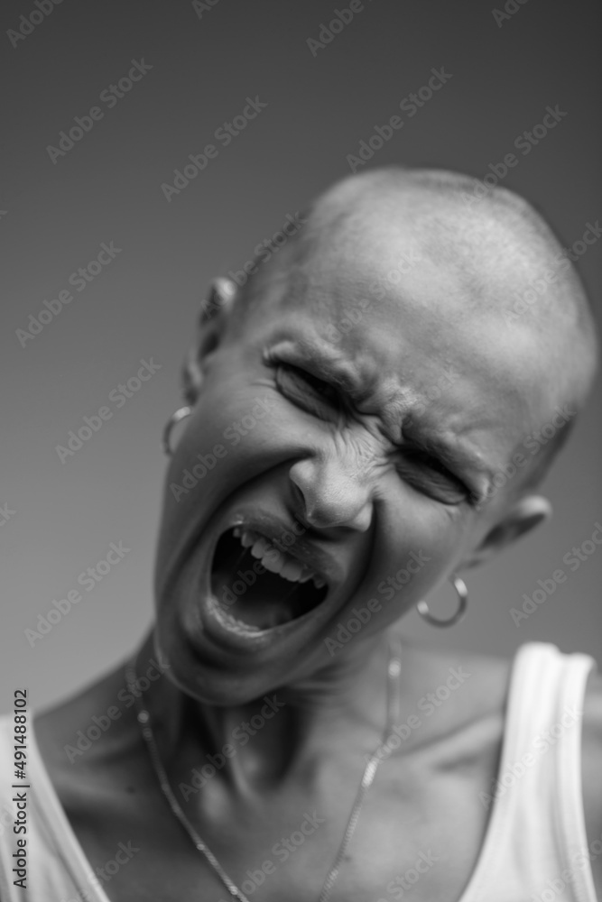 emotional studio portrait of a young attractive bald girl black and white image emotional studio portrait of a young attractive bald girl black and white image
