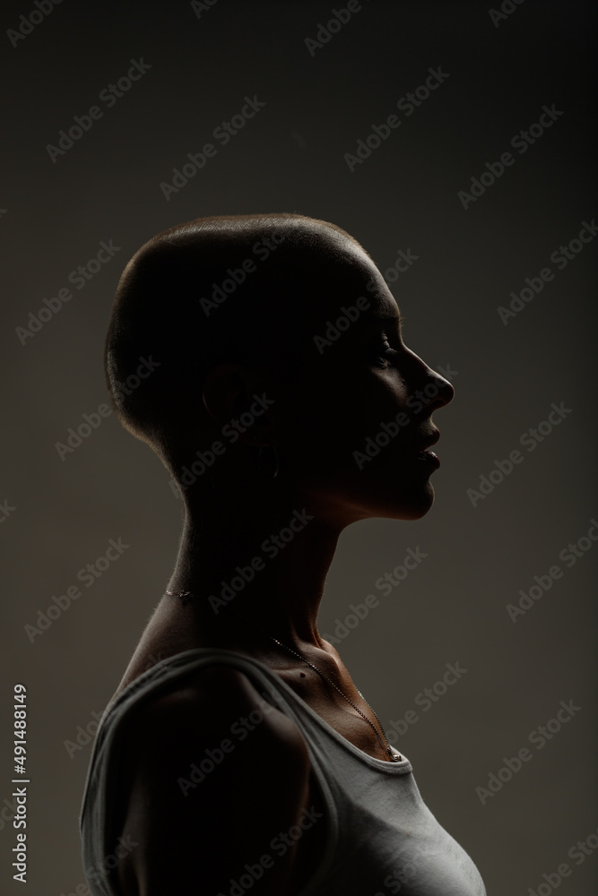 emotional studio portrait of a young attractive bald girl